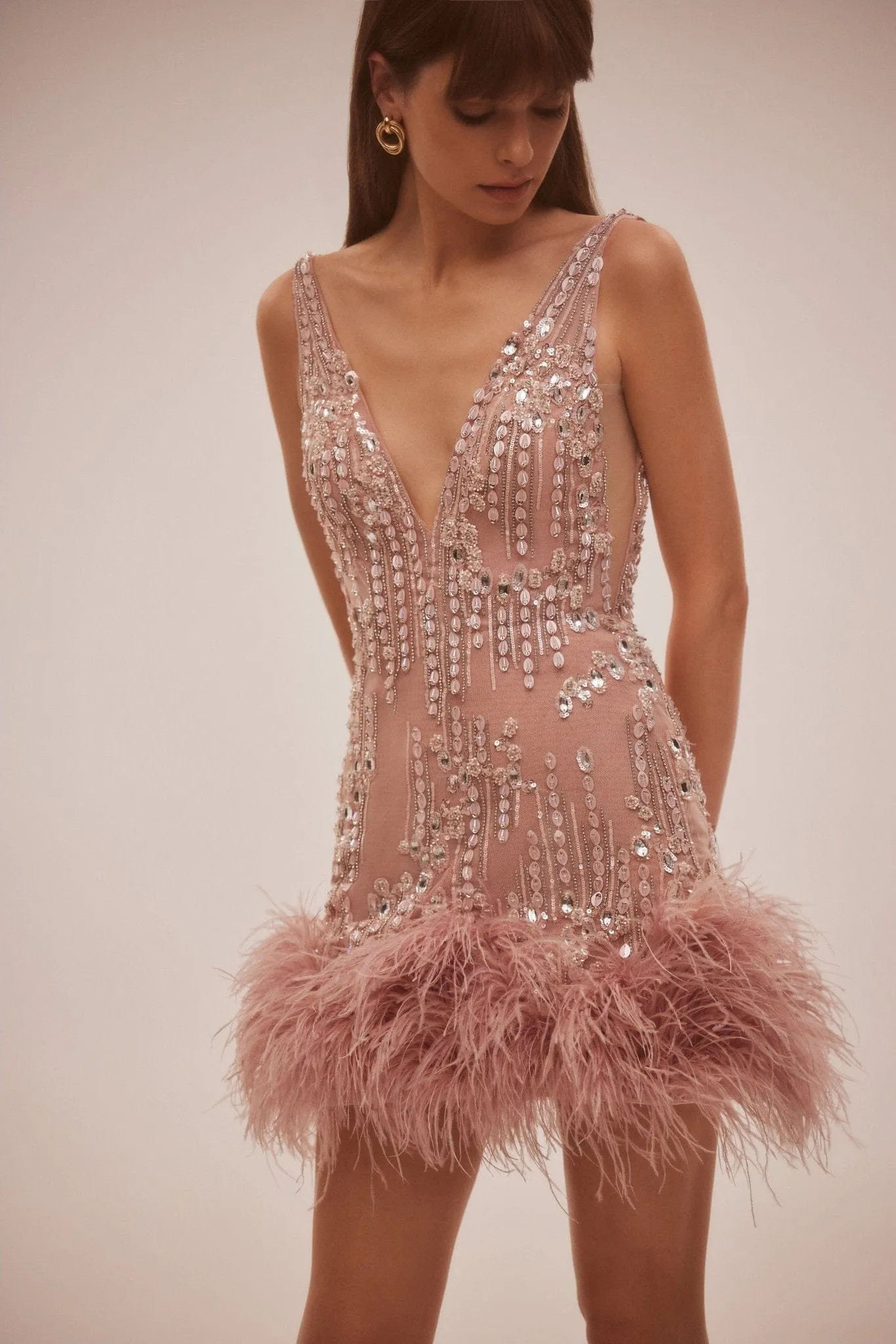 Fabulous mini dress on straps adorned with crystals and feathers